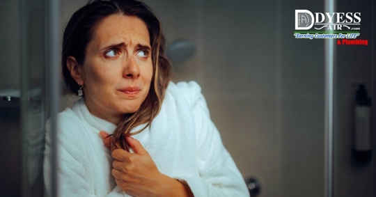 woman feeling cold due to lack of hot water