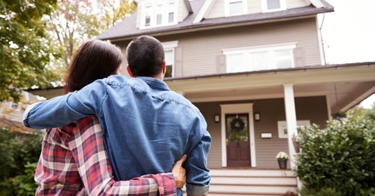 couple in front of their home