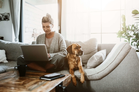 woman relaxing on couch with dog