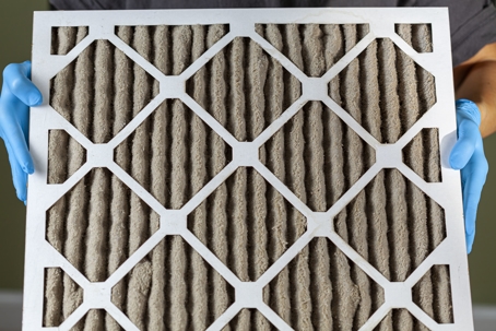 holding up dirty hvac filter