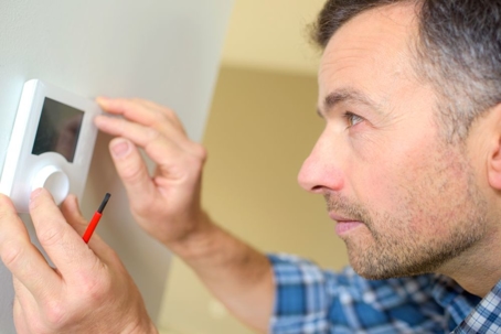 Man Setting Thermostat